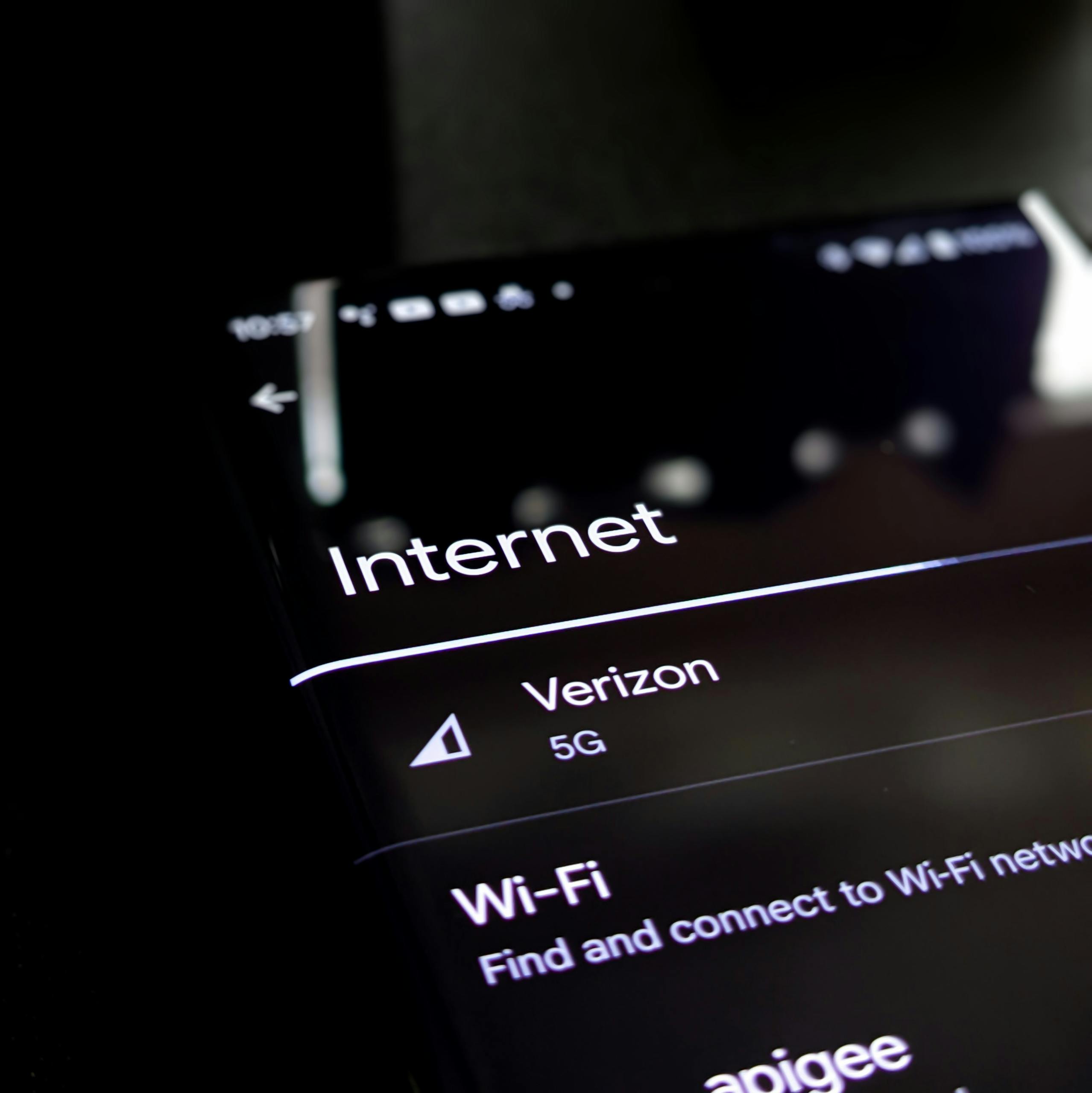 Close-up of a smartphone screen displaying internet connection details with Verizon 5G and Wi-Fi options.